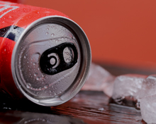 close up of a soda can on ice showcasing condensation and metallic texture refreshing drink for any occasion