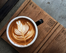 coffee cup with latte art on wooden surface showcasing intricate design perfect for coffee lovers 4 coffee types